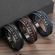 Three braided leather bracelets on a wooden surface with a dark background