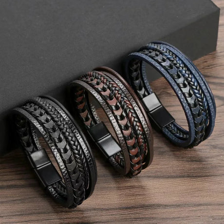 Three braided leather bracelets on a wooden surface with a dark background