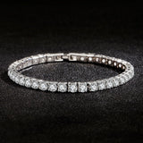 Silver bracelet with clear stones on a black background