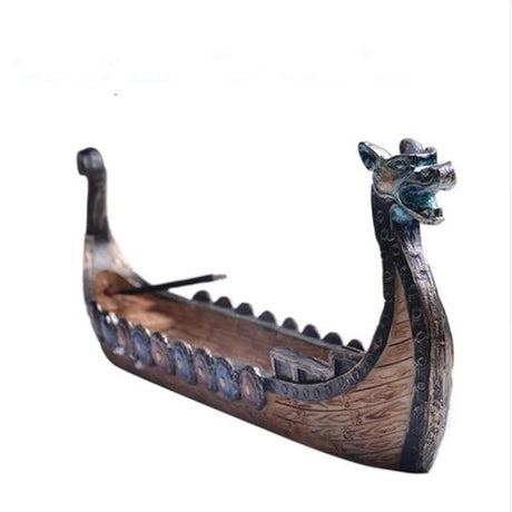 Model of a Viking longship with dragon head on a white background