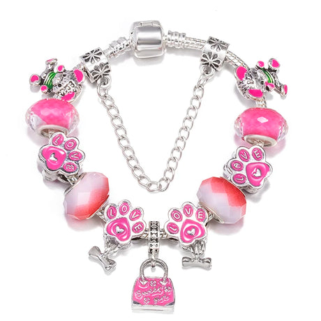 Bracelet with pink paw print charms and silver accents on a white background