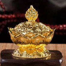 Gold decorative item on a wooden stand with a blurred background