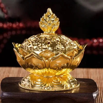 Gold decorative item on a wooden stand with a blurred background