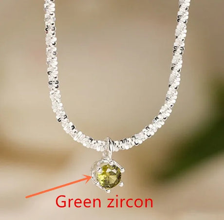 Necklace with a green zircon stone on a blurred background