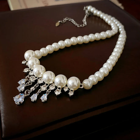 Pearl necklace with crystal drops on a dark surface