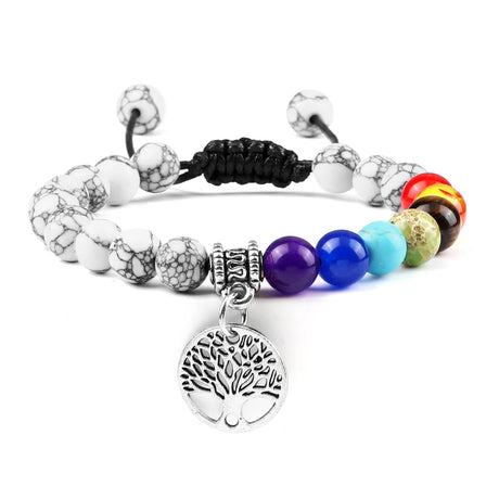 Multicolored beaded bracelet with a silver tree of life charm on a white background