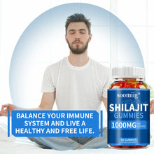 Person holding a bottle of soomiig Shilajit Gummies with text promoting overall wellness balance.