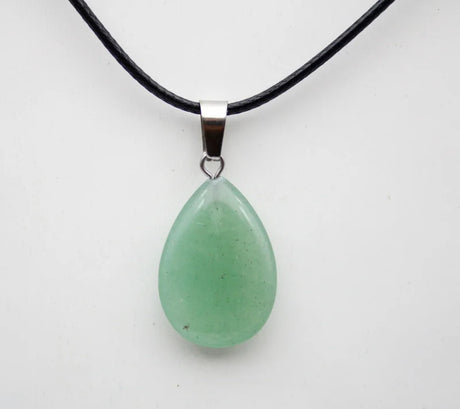 Teardrop-shaped green pendant on a black cord against a white background
