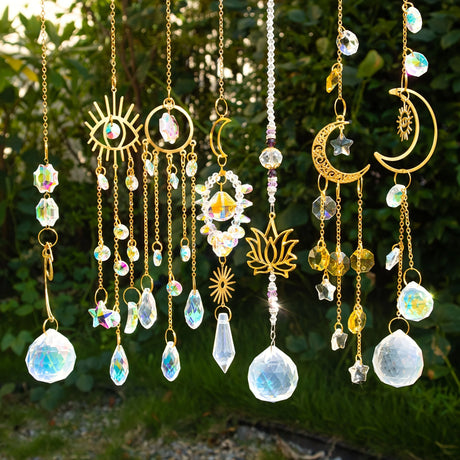 Decorative hanging ornaments with crystals and gold elements against a natural background