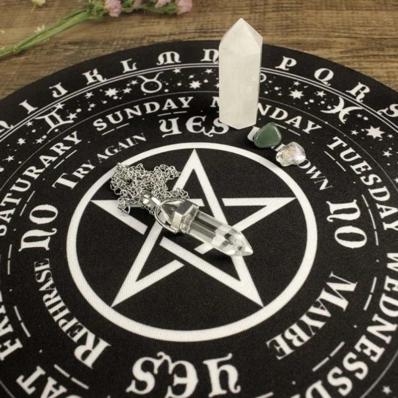 Crystal objects on a black circular mat with white text and symbols