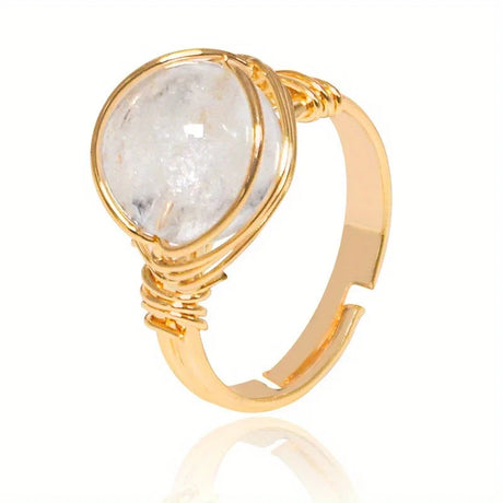 Gold ring with a large stone on a white background