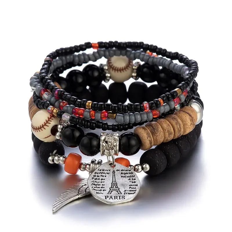 Stack of beaded bracelets with sports balls and a Paris charm on a white background