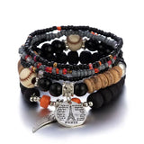 Stack of beaded bracelets with sports balls and a Paris charm on a white background