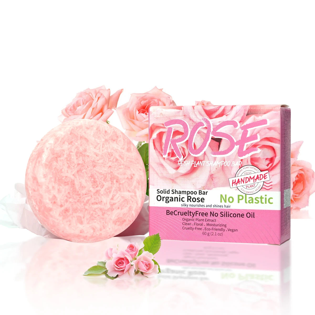 Pink solid shampoo bar with packaging featuring roses on a white background