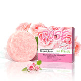 Pink solid shampoo bar with packaging featuring roses on a white background