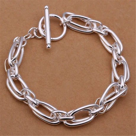 Silver chain bracelet on a brown background