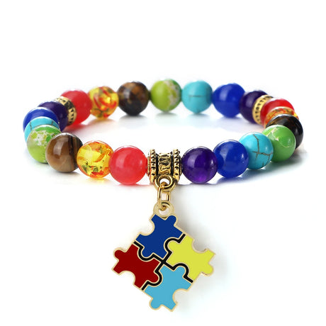 Colorful beaded bracelet with a puzzle piece charm on a white background