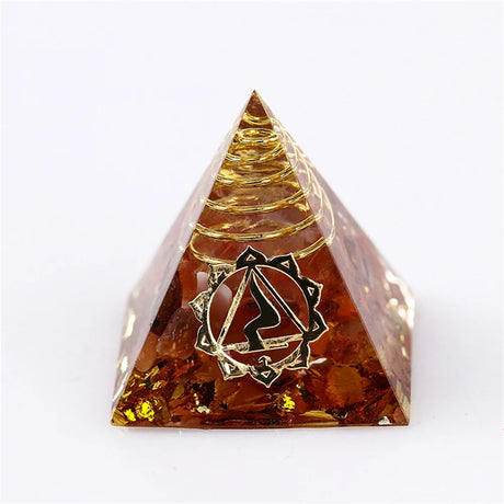 Pyramid-shaped amber crystal with a logo on a white background