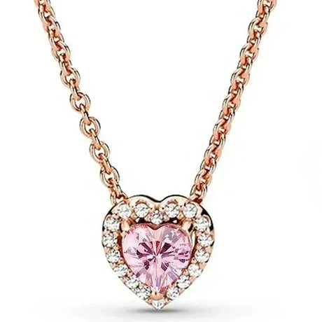 Heart-shaped necklace with pink gemstone and rose gold chain on a white background