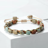 Beaded bracelet with natural stone beads on a white surface