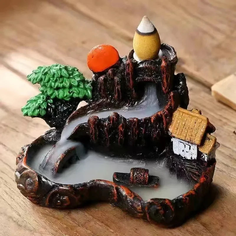 Decorative miniature landscape with a pond, trees, and buildings on a wooden surface