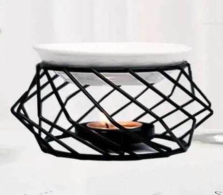 Black geometric candle holder with a candle on a white background