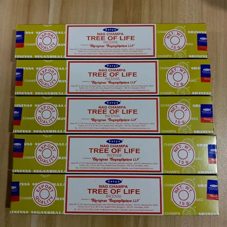 Multiple boxes of Nag Champa Tree of Life incense on a wooden surface