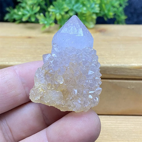 Crystal rock held in a hand with a natural background