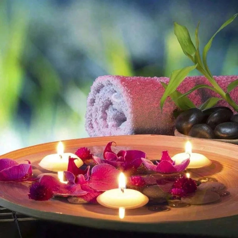 Spa setting with candles, flowers, and a towel on a blurred natural background
