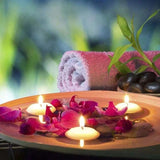 Spa setting with candles, flowers, and a towel on a blurred natural background