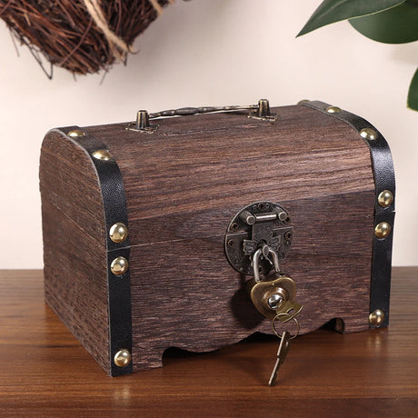 Wooden treasure chest with a lock and key on a wooden surface