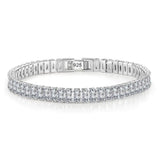 Silver bracelet with clear stones on a white background
