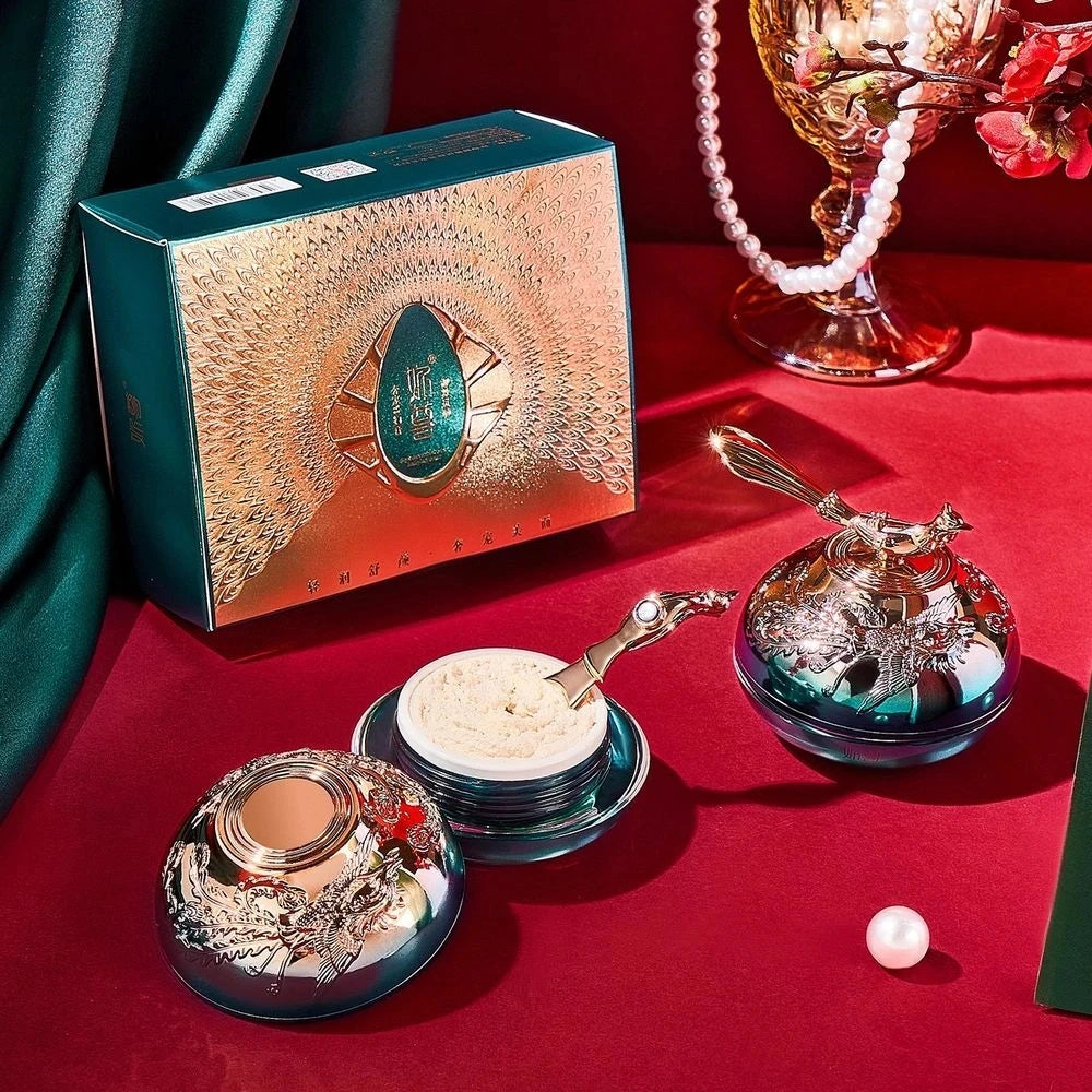 Makeup set with decorative boxes on a red surface