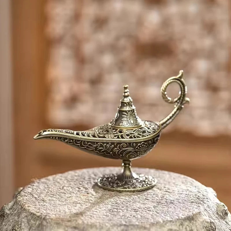 Decorative brass lamp on a stone surface with a blurred background