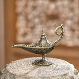 Decorative brass lamp on a stone surface with a blurred background