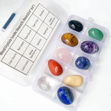 Set of mixed crystals in a clear plastic case with labels on a white background