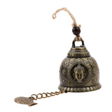 Decorative bell with Buddha face design on a white background