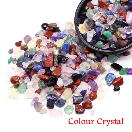 Colored Crystal stones with a bowl of stones on a white background.