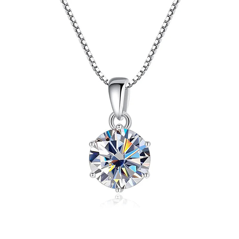 Silver necklace with a round, clear gemstone pendant on a white background