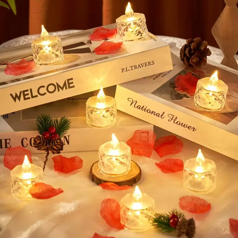 Flickering candles on a decorative setup with books and rose petals.
