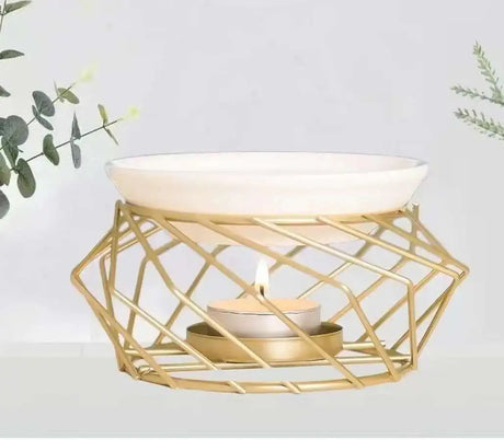 Gold geometric candle holder with a white bowl on a light background