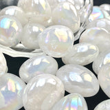 White iridescent beads on a dark background