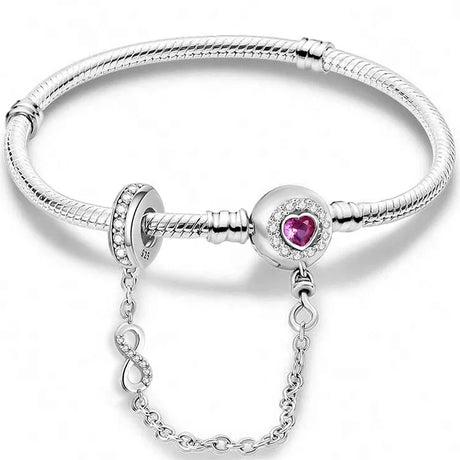 Silver bracelet with a heart-shaped pink gemstone on a white background