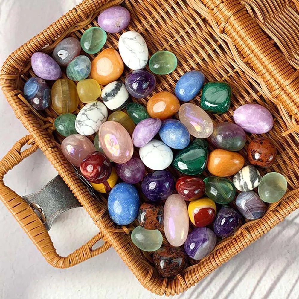 Assorted colorful gemstones in a wicker basket on a light background