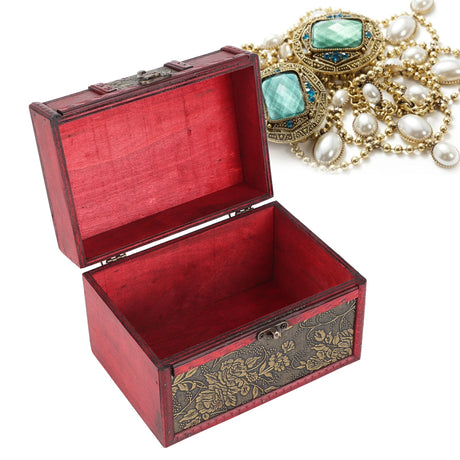 Open red jewelry box with ornate design, next to a necklace with turquoise and pearl stones on a white background.