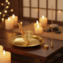 Gold incense burner with wooden matches and incense sticks on a white background