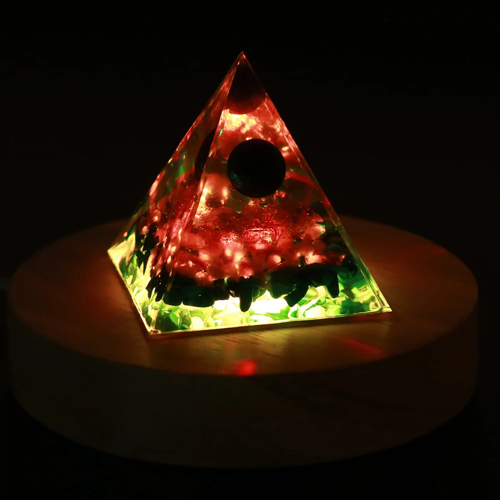 Triangular pyramid light with colorful LED lights on a dark background