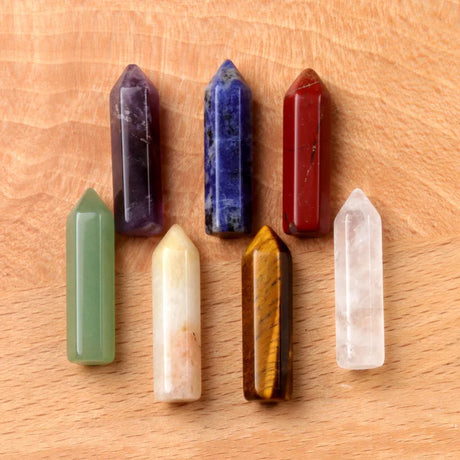 Set of colorful crystal sticks on a wooden surface