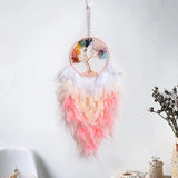 Decorative dreamcatcher with feathers and a colorful design on a white background