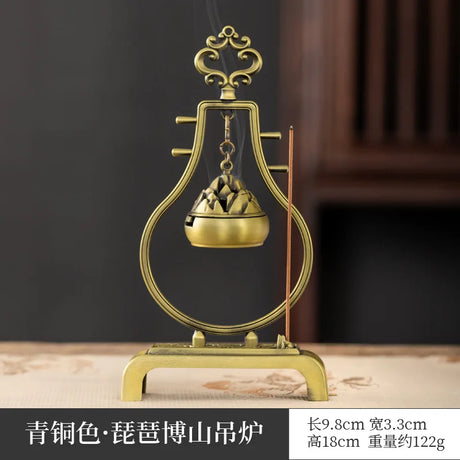 Bronze incense burner with decorative elements on a dark background